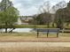 Community pond with water fountain and seating area at 234 Madison Ave, Acworth, GA 30102
