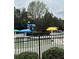 Waterslide at community pool with shade umbrellas and mature landscaping at 234 Madison Ave, Acworth, GA 30102