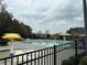 Community pool featuring lounge seating, shade umbrellas, and mature trees at 234 Madison Ave, Acworth, GA 30102