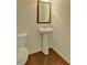 Charming powder room featuring a pedestal sink and hardwood floors at 234 Madison Ave, Acworth, GA 30102