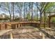 Wooden deck with built-in fire pit, perfect for relaxing evenings in the backyard at 3378 Peachtree Chase, Duluth, GA 30096