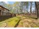 Large backyard with lush lawn, mature trees, and spacious wooden deck at 3378 Peachtree Chase, Duluth, GA 30096