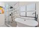 Bright bathroom features separate glass shower, soaking tub, and modern fixtures and accents at 3378 Peachtree Chase, Duluth, GA 30096