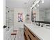 Bright bathroom featuring modern vanity, tub/shower with glass door, and decorative accents at 3378 Peachtree Chase, Duluth, GA 30096