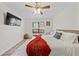 Comfortable bedroom with ceiling fan, window with wooded views, and light wood flooring at 3378 Peachtree Chase, Duluth, GA 30096