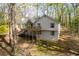 Two-story home with a deck surrounded by mature trees at 3378 Peachtree Chase, Duluth, GA 30096