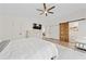 Spacious main bedroom showcasing a sliding barn door, ceiling fan, and natural light at 3378 Peachtree Chase, Duluth, GA 30096