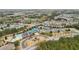 Aerial view of a community with a clubhouse, pool, tennis courts, and lush landscaping at 3800 Lake Pass Ln, Suwanee, GA 30024