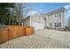 A beautiful backyard with a brick patio, wooden fence and a detached garage at 3800 Lake Pass Ln, Suwanee, GA 30024
