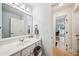 Bright bathroom with a white vanity, a framed mirror, and views of another room at 3800 Lake Pass Ln, Suwanee, GA 30024
