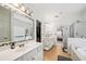 Spacious bathroom featuring double sinks, a bathtub, and a shower, with tile flooring at 3800 Lake Pass Ln, Suwanee, GA 30024