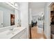 Bright bathroom showcasing a mirror, vanity with sink, and a view of a bedroom area at 3800 Lake Pass Ln, Suwanee, GA 30024