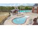 Relaxing community pool area featuring a covered seating area, kiddie pool, and plenty of lounge chairs at 3800 Lake Pass Ln, Suwanee, GA 30024