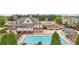 Beautiful community pool with sun loungers next to community clubhouse on a sunny day at 3800 Lake Pass Ln, Suwanee, GA 30024