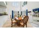 Elegant dining area with high ceilings, ornate wood table, and large windows with blue drapes at 3800 Lake Pass Ln, Suwanee, GA 30024