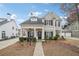 Charming two-story home featuring a welcoming front porch, landscaped yard, and classic architectural details at 3800 Lake Pass Ln, Suwanee, GA 30024