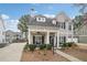Beautiful two-story home with covered porch, manicured landscaping, and a detached two car garage at 3800 Lake Pass Ln, Suwanee, GA 30024