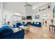 Bright living room with vaulted ceiling, fireplace, large windows, and stylish blue furniture at 3800 Lake Pass Ln, Suwanee, GA 30024