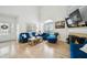 Bright living room with fireplace, lots of natural light, and stylish blue furniture at 3800 Lake Pass Ln, Suwanee, GA 30024