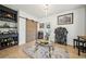 Elegant living room featuring a custom bar, wine storage, modern lighting, and a glass-top coffee table on a rug at 3800 Lake Pass Ln, Suwanee, GA 30024