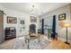 Charming living room featuring wine racks, modern lighting, and a glass-top coffee table on a decorative rug at 3800 Lake Pass Ln, Suwanee, GA 30024