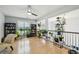 Bright loft space with hardwood floors, natural light, and a variety of houseplants at 3800 Lake Pass Ln, Suwanee, GA 30024