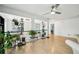 Bright loft featuring hardwood floors, a ceiling fan, natural light, and numerous potted plants at 3800 Lake Pass Ln, Suwanee, GA 30024