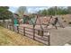 Community playground with swings, slides, and climbing structures, fenced in for safety at 3800 Lake Pass Ln, Suwanee, GA 30024