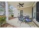 Charming front porch with a ceiling fan, black door with a wreath, and inviting chairs at 3800 Lake Pass Ln, Suwanee, GA 30024