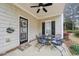 Cozy front porch with a ceiling fan, a black door, a welcome sign and outdoor seating at 3800 Lake Pass Ln, Suwanee, GA 30024