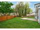 A lush backyard featuring a green lawn, wood fence and concrete patio perfect for outdoor activities at 5615 Crystal Hl, Stone Mountain, GA 30088