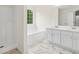 Bright bathroom offers double sinks, a shower, and a tub for ultimate relaxation at 5615 Crystal Hl, Stone Mountain, GA 30088