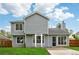 A charming two-story home with gray siding, a well-manicured lawn, and a welcoming front entrance at 5615 Crystal Hl, Stone Mountain, GA 30088