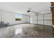 An empty two car garage with a window and a roll-up garage door at 5615 Crystal Hl, Stone Mountain, GA 30088