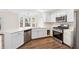 Modern kitchen with stainless steel appliances, white cabinets, and lots of counter space at 5615 Crystal Hl, Stone Mountain, GA 30088