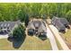 Beautifully landscaped property with an expansive home, detached garage, and lush green lawn at 5055 Stefan Ridge Way, Buford, GA 30519