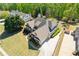 Expansive home with mature landscaping, a long driveway, and an attached three-car garage at 5055 Stefan Ridge Way, Buford, GA 30519