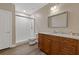 Bathroom with granite countertop vanity, glass enclosed shower, and wood laminate flooring at 5055 Stefan Ridge Way, Buford, GA 30519