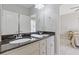 Bathroom featuring double sink vanity with granite counters and white cabinets at 5055 Stefan Ridge Way, Buford, GA 30519