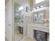 Bathroom area featuring vanity table with storage, decorative mirror and lighting, and large mirror at 5055 Stefan Ridge Way, Buford, GA 30519