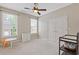 Neutral bedroom featuring ceiling fan, closet, and table and chair at 5055 Stefan Ridge Way, Buford, GA 30519