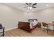Bedroom with a wood sleigh bed, ceiling fan, desk and wood floors at 5055 Stefan Ridge Way, Buford, GA 30519