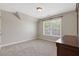 Bedroom featuring a neutral wall color, carpeted floors and a large window at 5055 Stefan Ridge Way, Buford, GA 30519