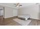 Bedroom with a ceiling fan, double door closet, and wood laminate flooring at 5055 Stefan Ridge Way, Buford, GA 30519