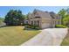 Lovely house with a lush lawn and a spacious driveway that leads to an attached garage at 5055 Stefan Ridge Way, Buford, GA 30519