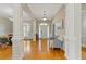 Elegant foyer featuring hardwood floors, classic columns, and a view into the dining room at 5055 Stefan Ridge Way, Buford, GA 30519