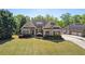 Charming brick home featuring manicured landscaping and attached garage at 5055 Stefan Ridge Way, Buford, GA 30519