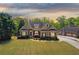 Charming brick home featuring manicured landscaping and attached garage at 5055 Stefan Ridge Way, Buford, GA 30519