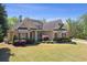 Beautiful brick home with meticulously maintained landscaping and a three-car garage at 5055 Stefan Ridge Way, Buford, GA 30519