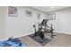 Finished basement gym with workout equipment, neutral walls and laminate floor at 5055 Stefan Ridge Way, Buford, GA 30519